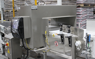 Image of a fortress stealth large bag metal detector in an automated packaging line.